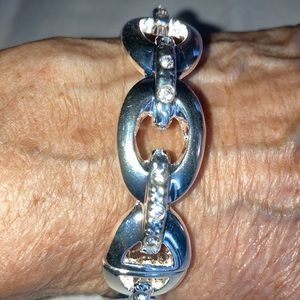 NWOT shiny silvertone round bracelet has oval shapes w/ rhinestone lines $22